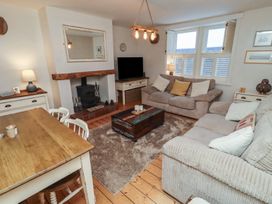 A living room with a sofa and coffee table at Corner Cottage Seahouses