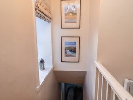 A hallway with photos and a lantern at Corner Cottage in Seahouses