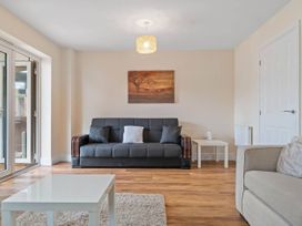 A living room with sofa and table at the property location