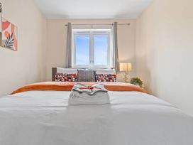 A bedroom with a bed and window at The Old Barn in Manchester