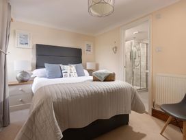 A bedroom with a bed and en suite bathroom at The Granary near St Merryn