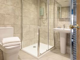 A bathroom with a shower, toilet and sink at The Granary, Engollan near St Merryn
