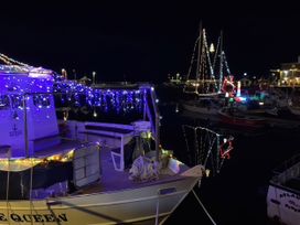 A boat with lights at a harbor at The Granary, Engollan near St Merryn