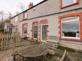 A house with a garden and seating area at 3 Bay View Terrace in Llandegfan