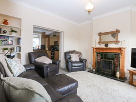 A living room with furniture and a fireplace at 3 Bay View Terrace in Llandegfan