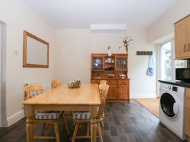 A dining room with a table and chairs at 3 Bay View Terrace in Llandegfan
