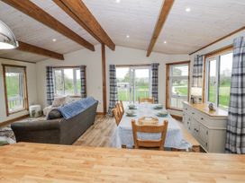 A dining room with a table and chairs at Willow Lodge in Admaston near Abbots Bromley