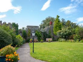 A garden with a pathway and benches at Derwent in Ulverston