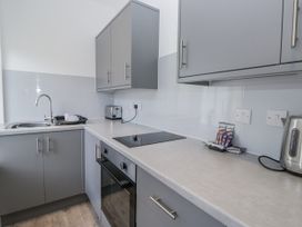 A kitchen with a sink and kitchen cabinets at Derwent in Ulverston