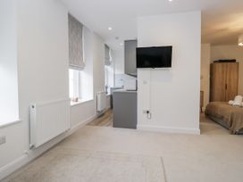 A studio apartment with kitchen area and bed at Derwent in Ulverston