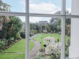 A garden with a stone wall and benches at Derwent in Ulverston
