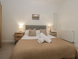 A bedroom with a double bed and bedside tables at Derwent in Ulverston