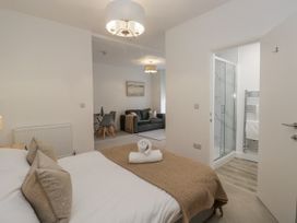 A bedroom with a bed and shower in Derwent, Ulverston