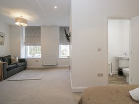 A living room with a sofa and television at Derwent in Ulverston
