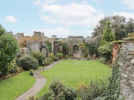 A garden with stone walls and seating area at Derwent in Ulverston