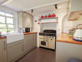 A kitchen with a sink and cooker at Blowing House Cottage near Perranporth
