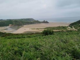A view of the beach and ocean with cliffs in the background at 