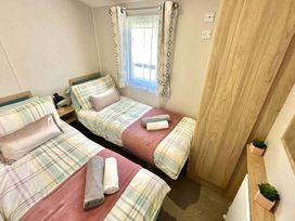 A bedroom with two beds and a window at the property in location