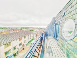 A balcony overlooking a city street at a property