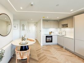 A kitchen with a dining table and chairs at The Old Barn in Manchester