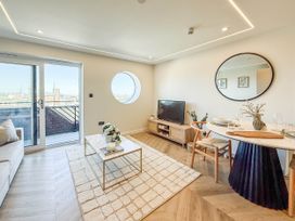 A living room with a sofa, coffee table and television at 