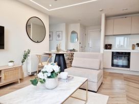 A living room with a sofa and dining table at the property