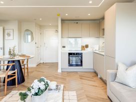 A kitchen with dining area and modern furniture at The Old Barn in Manchester