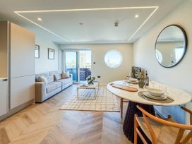 A living room with a couch and dining table at 