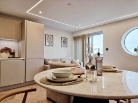 An open plan living area with a dining table and a sofa at 