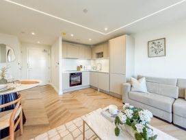 A living room with kitchen area and dining setup at the property