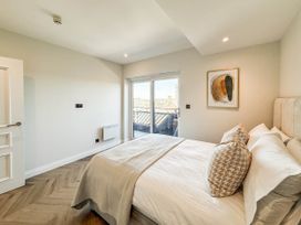 A bedroom with a bed and artwork on the wall at The Old Barn in Manchester