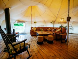 A living area with a sofa and coffee table in a tent