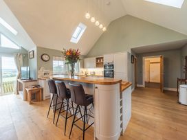 A kitchen with a bar, stove and television at The Old Barn in Manchester