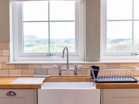 A kitchen sink with a tap and draining rack at The Old Barn in Manchester