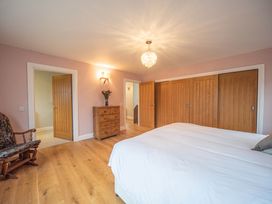 A bedroom with a bed and dresser at The Old Barn in Manchester