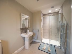 A bathroom with a shower and sink at The Old Barn in Manchester