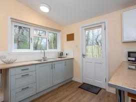 A kitchen with cabinets and a sink at Kilninver Chalet 