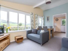 A living room with a sofa and dining area at The Old Barn in Manchester