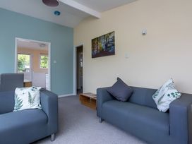 A living room with two sofas and a table at The Old Barn in Manchester