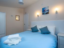 A bedroom with a bed and wardrobe at The Old Barn in Manchester