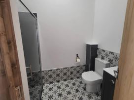 A bathroom with a toilet and shower at Old Highwood Barns Dunkeswell