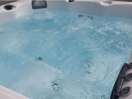 A hot tub filled with water at Old Highwood Barns Dunkeswell