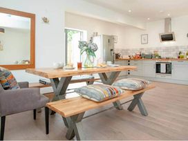 A dining area with a table and bench at The Old Barn in Manchester