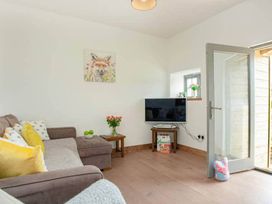 A living room with a sofa and television at the property