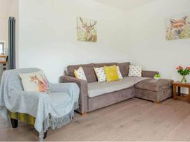 A living room with a sofa and armchair at The Old Barn in Manchester