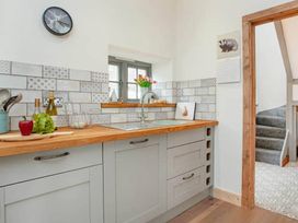 A kitchen with a sink and various kitchen items in a home
