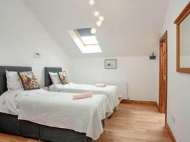 A bedroom with two beds and a skylight at The Old Barn in Manchester