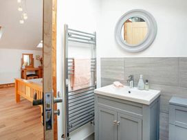 A bathroom with a sink, towel rack, and mirror at the property