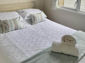 A bed with pillows and towels in a bedroom