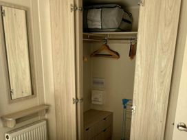 A closet with hangers and a storage bag at 